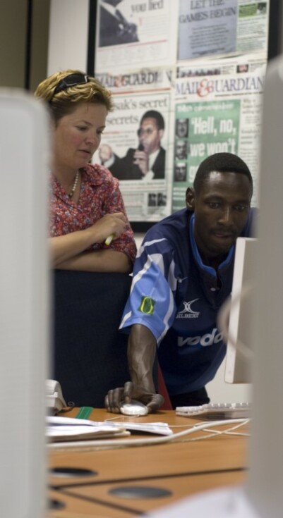 Woman and man in a newsroom